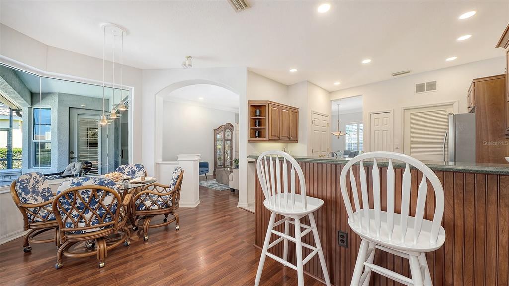 665 Crane Prairie Way Osprey, FL 34229 - Photo 22 of 61 a view of a dining room with furniture window and wooden floor
