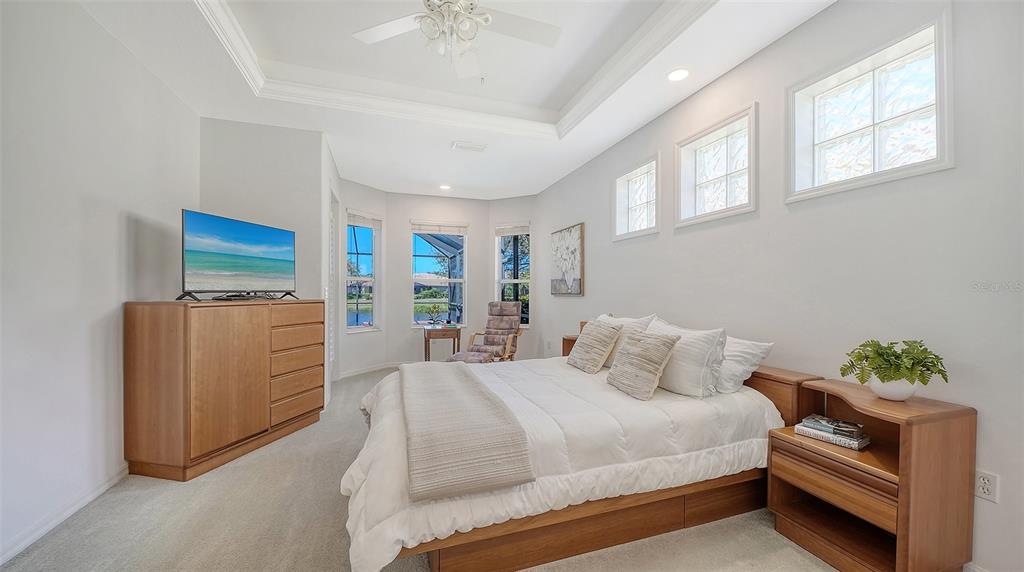 665 Crane Prairie Way Osprey, FL 34229 - Photo 29 of 61 a bedroom with a bed and a couch