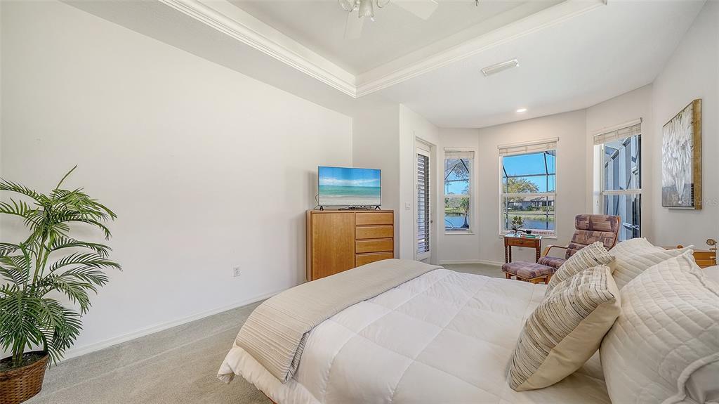 665 Crane Prairie Way Osprey, FL 34229 - Photo 30 of 61 a bedroom with a bed and with potted plant
