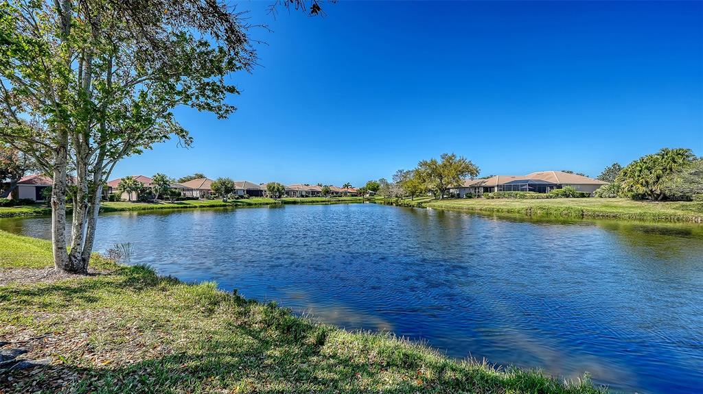 665 Crane Prairie Way Osprey, FL 34229 - Photo 3 of 61 a view of a lake with houses in the background