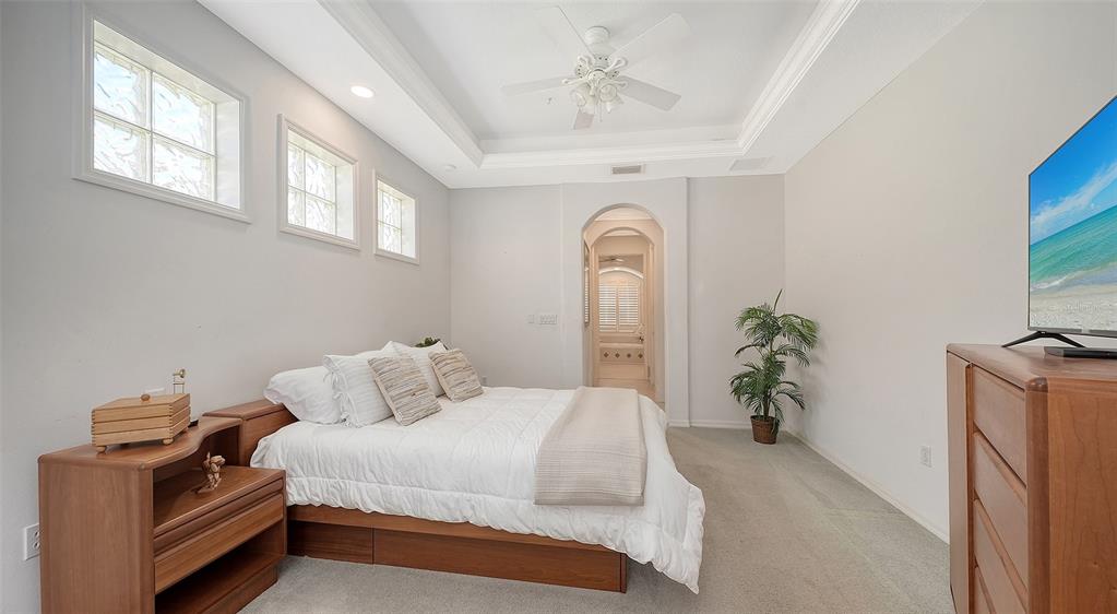 665 Crane Prairie Way Osprey, FL 34229 - Photo 32 of 61 a bedroom with a bed and a chandelier