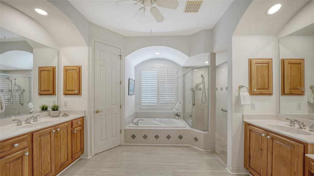 665 Crane Prairie Way Osprey, FL 34229 - Photo 33 of 61 a spacious bathroom with a double vanity sink a mirror and a bathtub