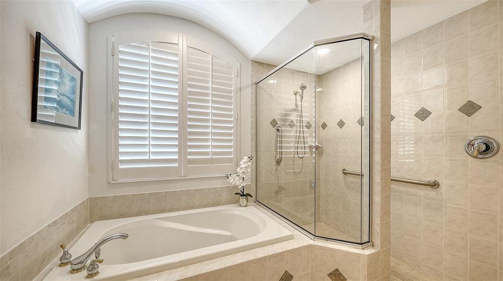 665 Crane Prairie Way Osprey, FL 34229 - Photo 35 of 61 a bathroom with a bathtub and shower