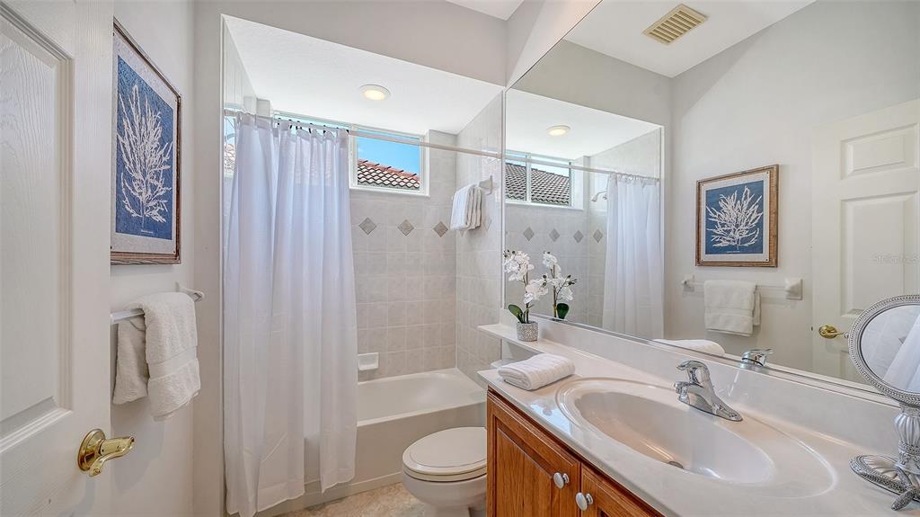 665 Crane Prairie Way Osprey, FL 34229 - Photo 38 of 61 a bathroom with a granite countertop sink toilet and shower