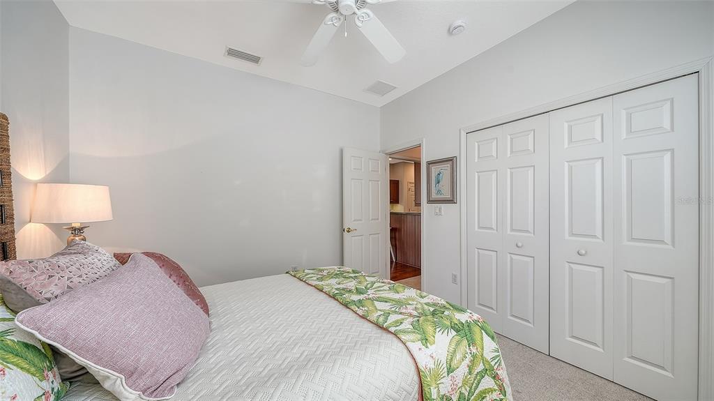 665 Crane Prairie Way Osprey, FL 34229 - Photo 40 of 61 a bedroom with a bed and a chandelier fan
