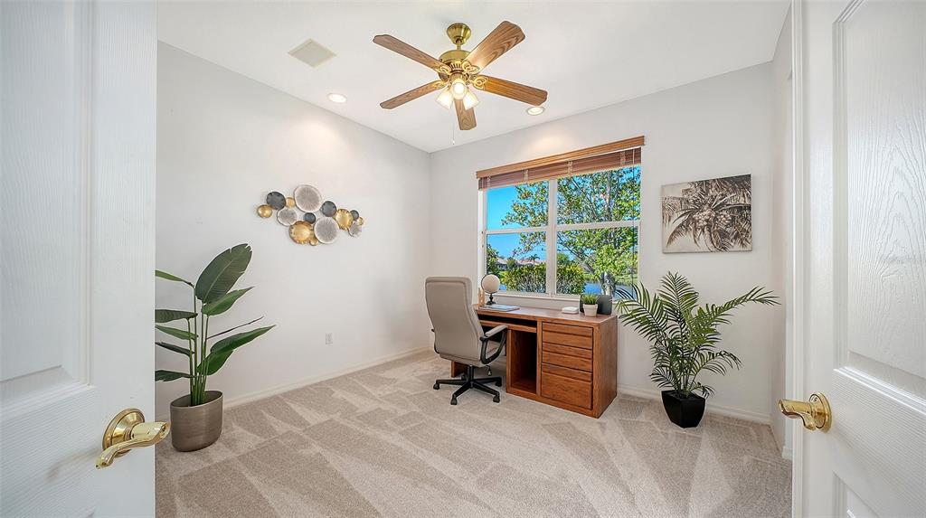 665 Crane Prairie Way Osprey, FL 34229 - Photo 41 of 61 a view of a workspace with furniture and a window