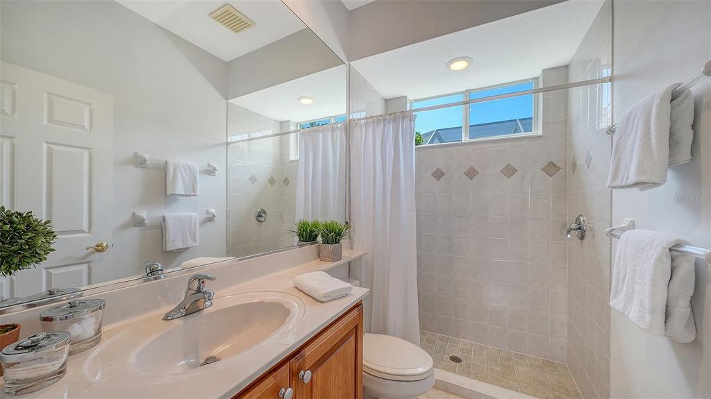 665 Crane Prairie Way Osprey, FL 34229 - Photo 44 of 61 a bathroom with a sink toilet and shower