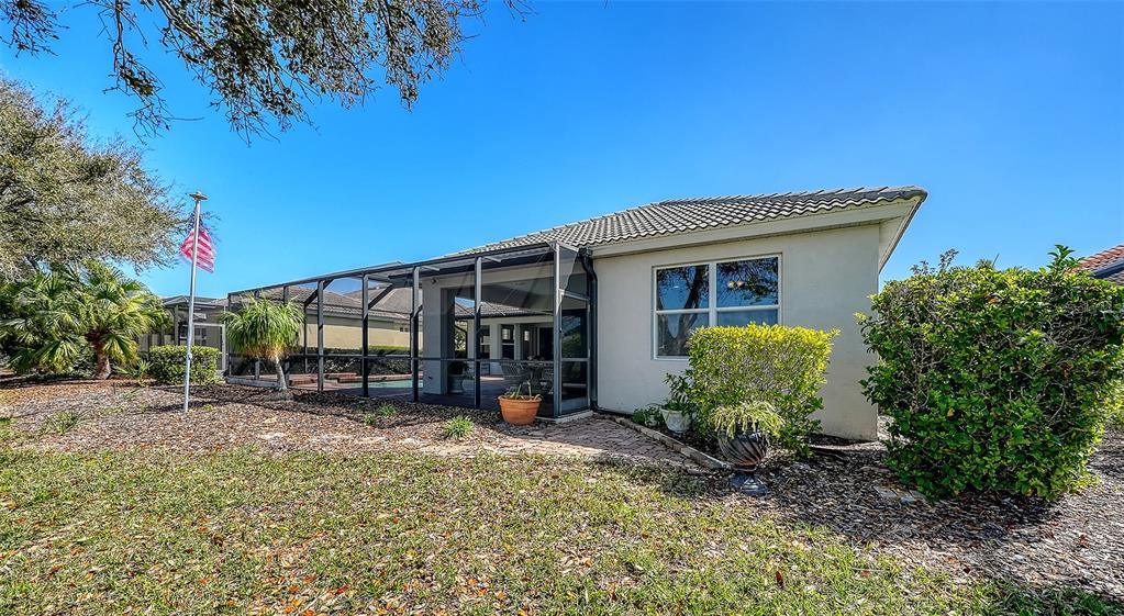 665 Crane Prairie Way Osprey, FL 34229 - Photo 45 of 61 a view of a house with a backyard and porch