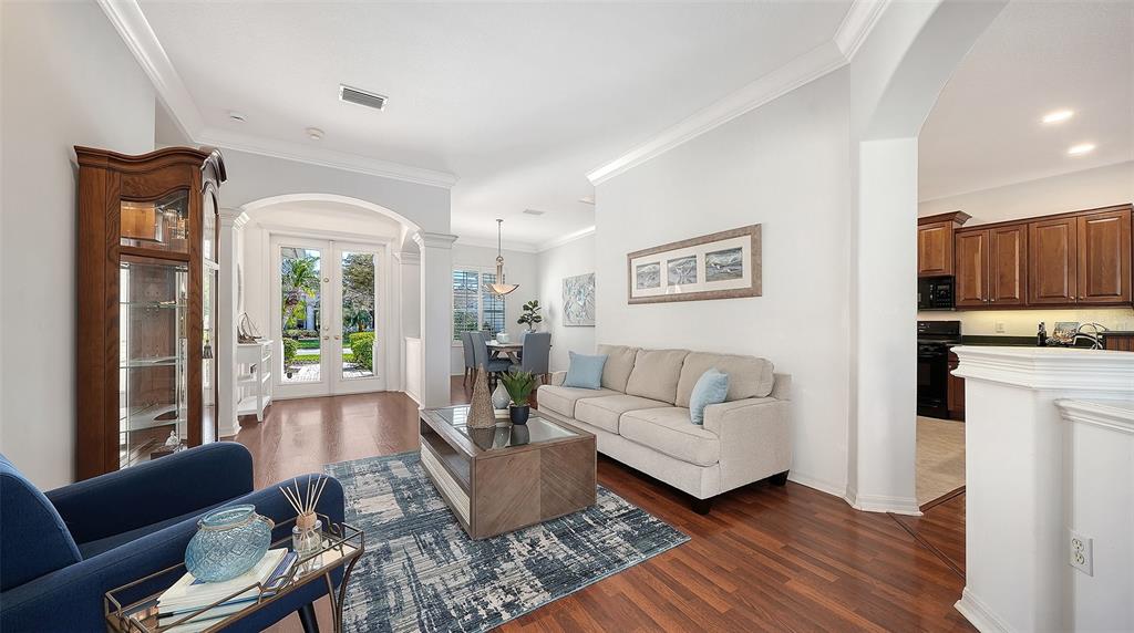 665 Crane Prairie Way Osprey, FL 34229 - Photo 6 of 61 a living room with furniture and a kitchen view