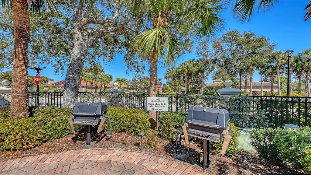 665 Crane Prairie Way Osprey, FL 34229 - Photo 61 of 61 a garden with a bench and some trees