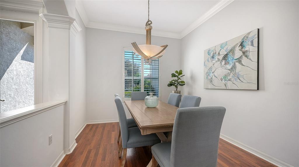 665 Crane Prairie Way Osprey, FL 34229 - Photo 9 of 61 a view of a dining room with furniture window and wooden floor