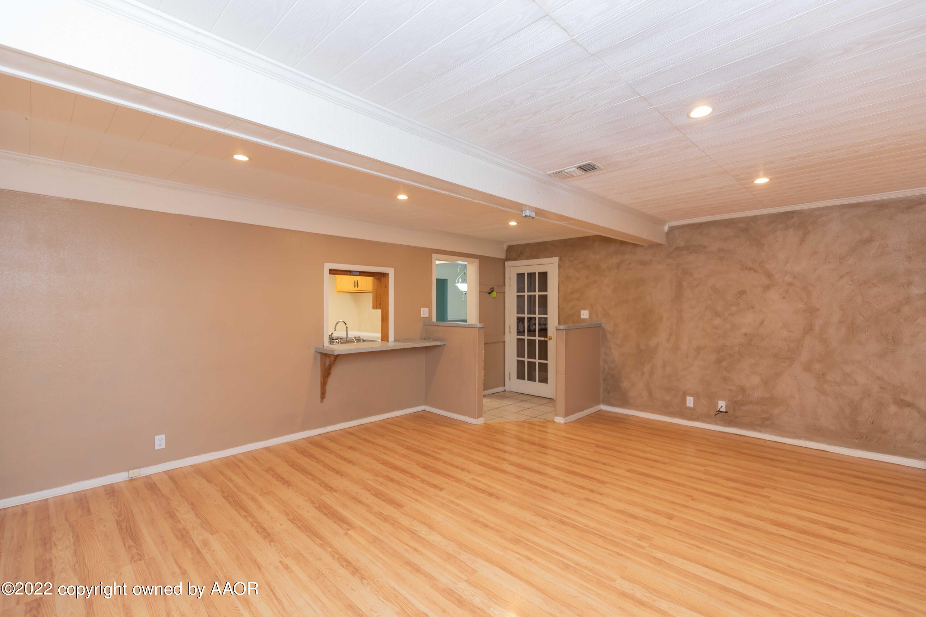 1302 Potter Street Borger, TX 79007 - Photo 13 of 53 a view of empty room with wooden floor and fan