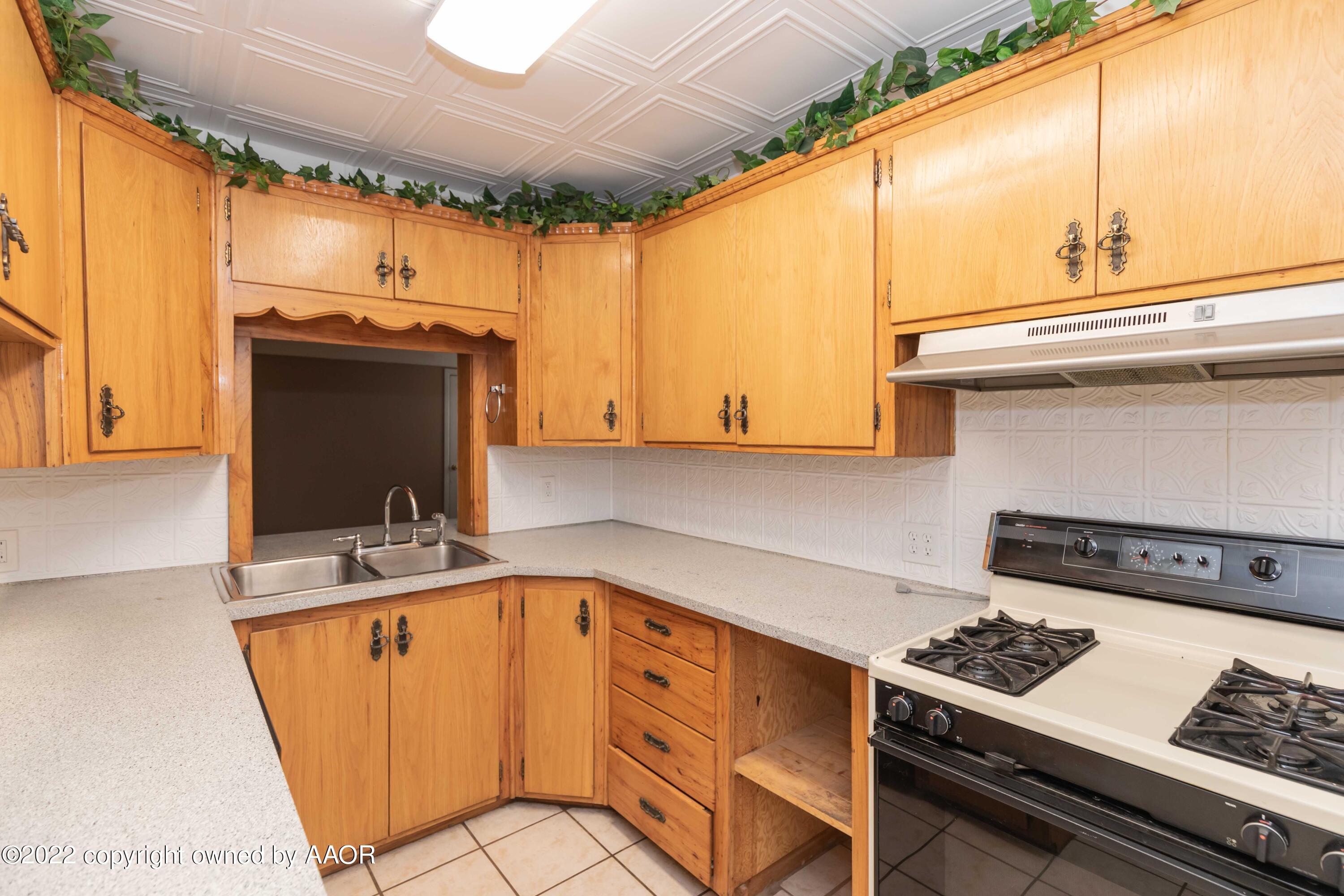 1302 Potter Street Borger, TX 79007 - Photo 17 of 53 a kitchen with stainless steel appliances granite countertop a sink and cabinets