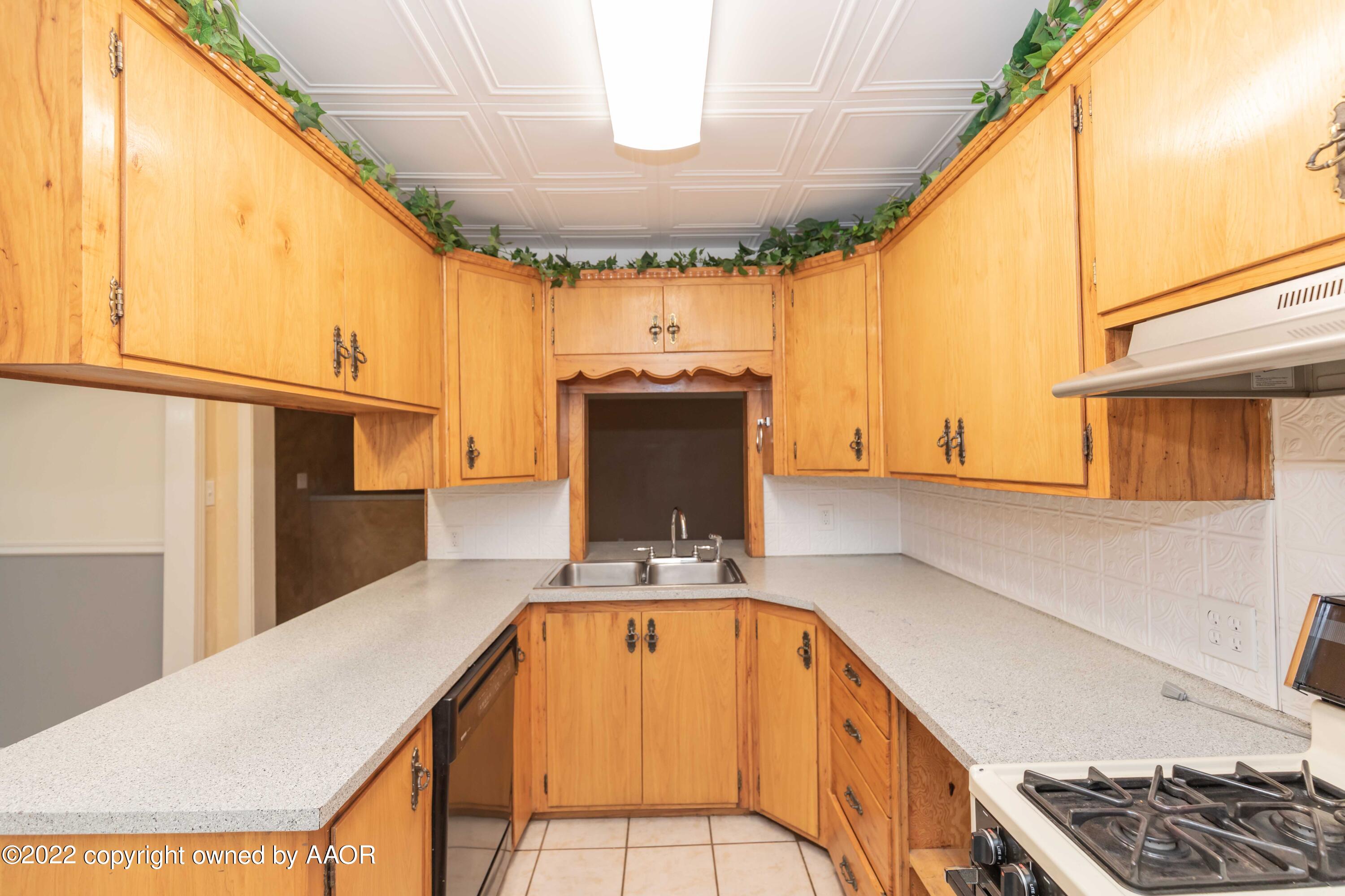 1302 Potter Street Borger, TX 79007 - Photo 18 of 53 a view of kitchen with stainless steel appliances granite countertop a sink and cabinets