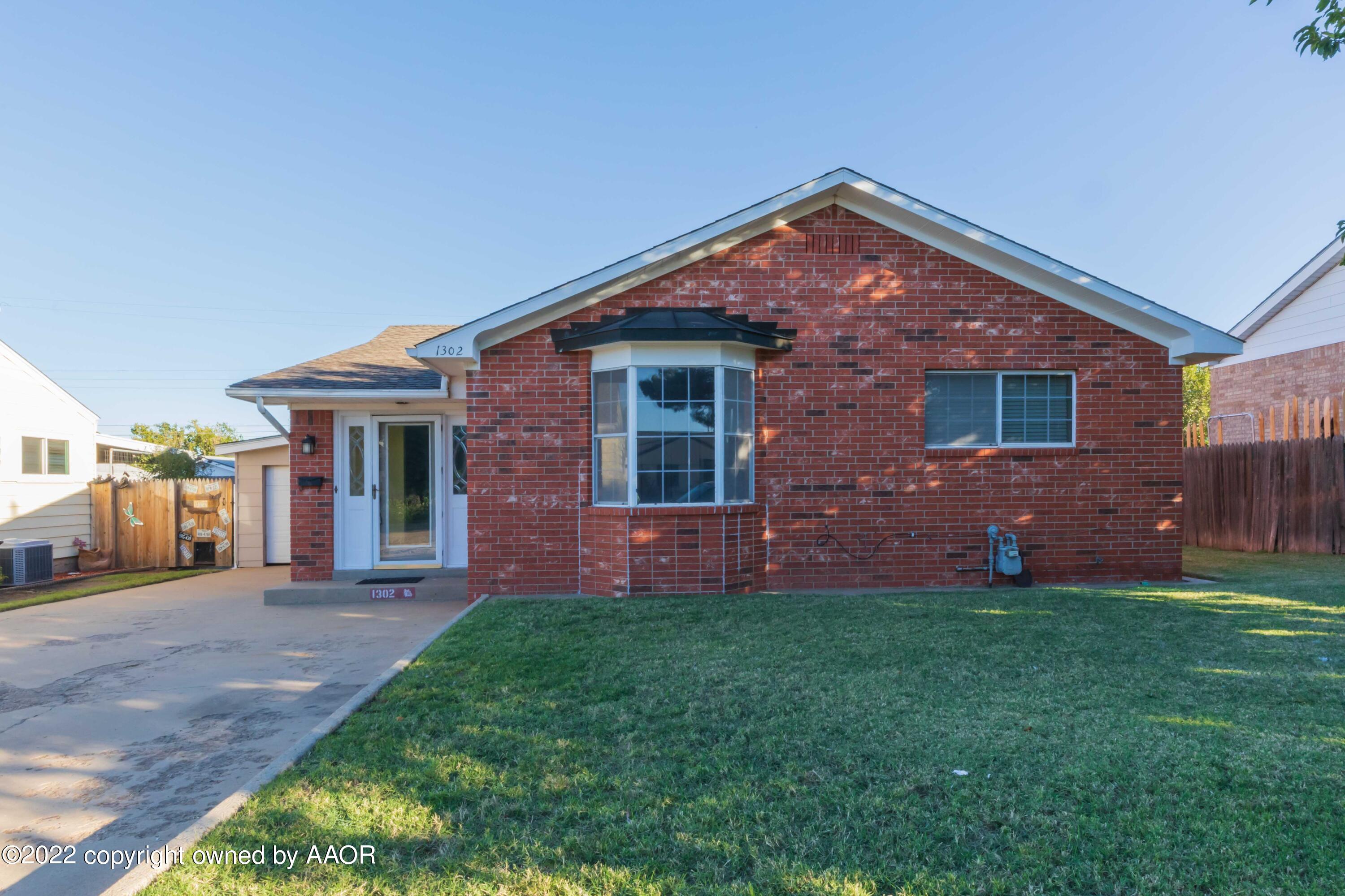 1302 Potter Street Borger, TX 79007 - Photo 2 of 53 a front view of a house with a yard and garage