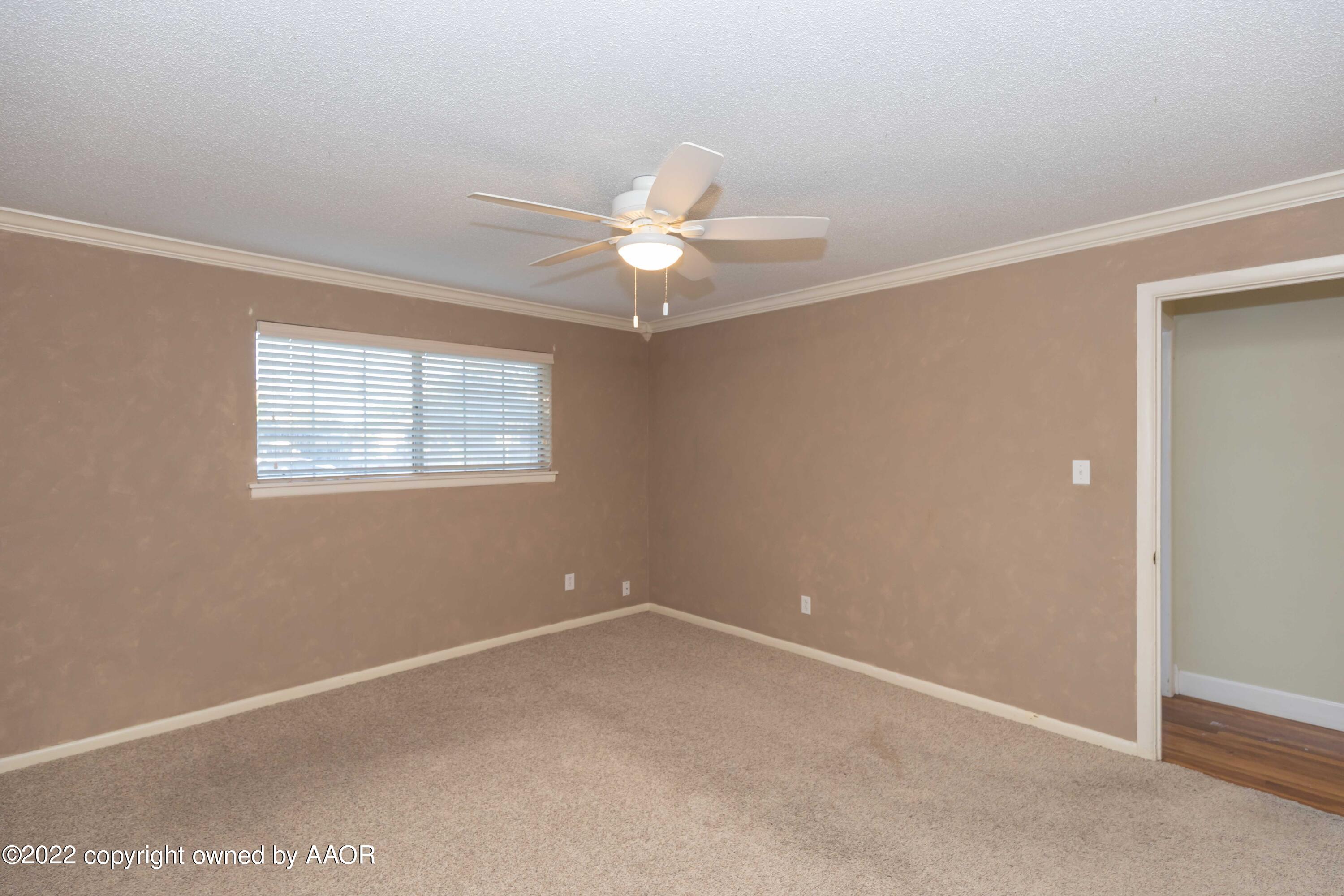 1302 Potter Street Borger, TX 79007 - Photo 21 of 53 an empty room with a window and a fan