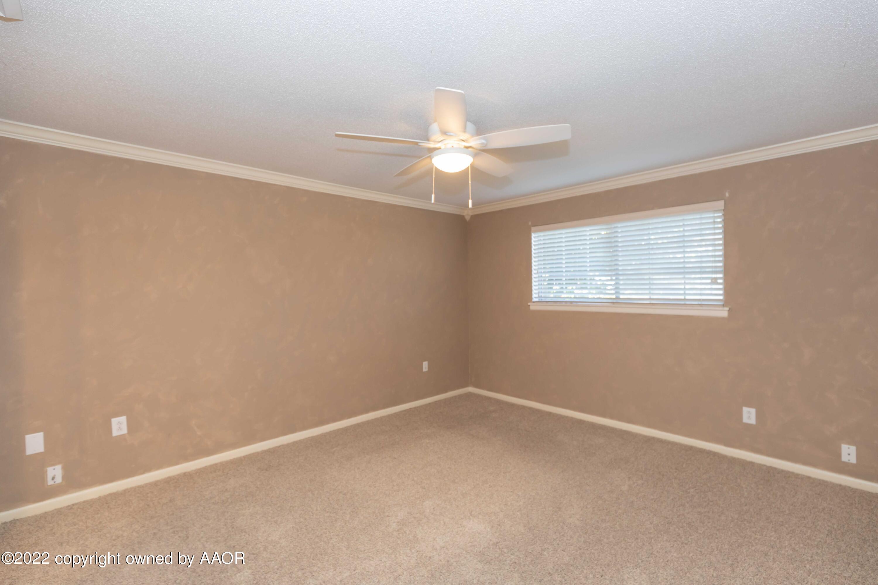 1302 Potter Street Borger, TX 79007 - Photo 23 of 53 an empty room with a window and a fan