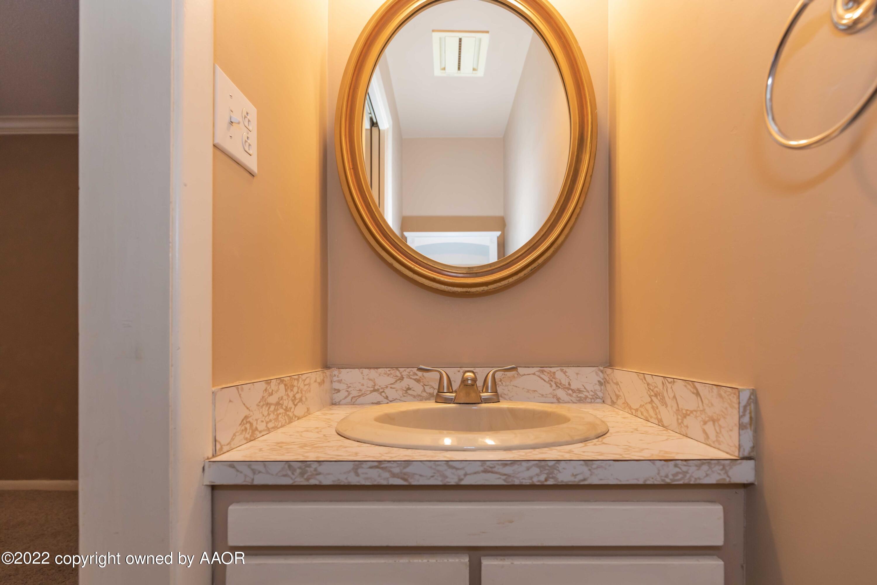 1302 Potter Street Borger, TX 79007 - Photo 25 of 53 a bathroom with a sink and a mirror