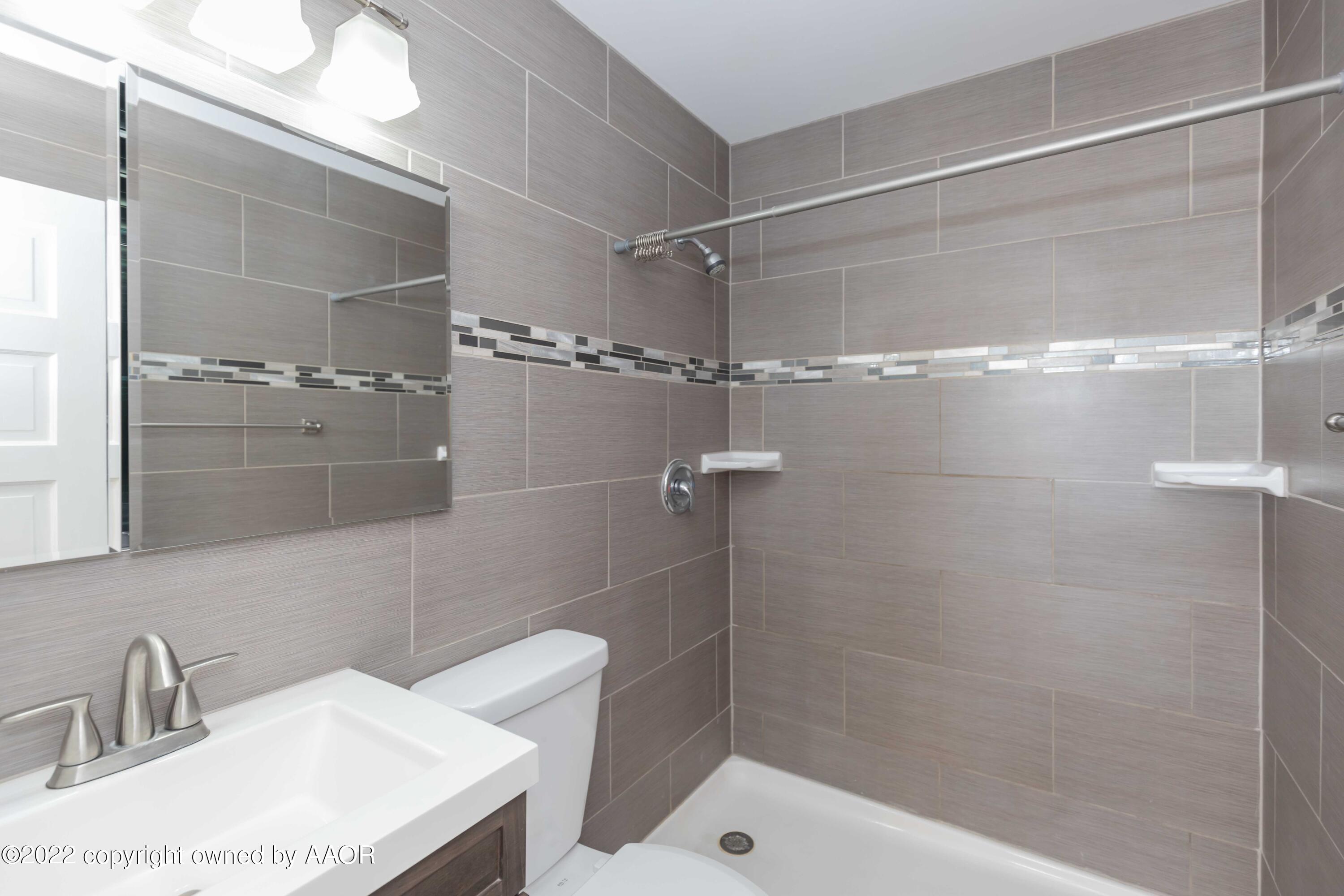 1302 Potter Street Borger, TX 79007 - Photo 30 of 53 a bathroom with a sink and shower