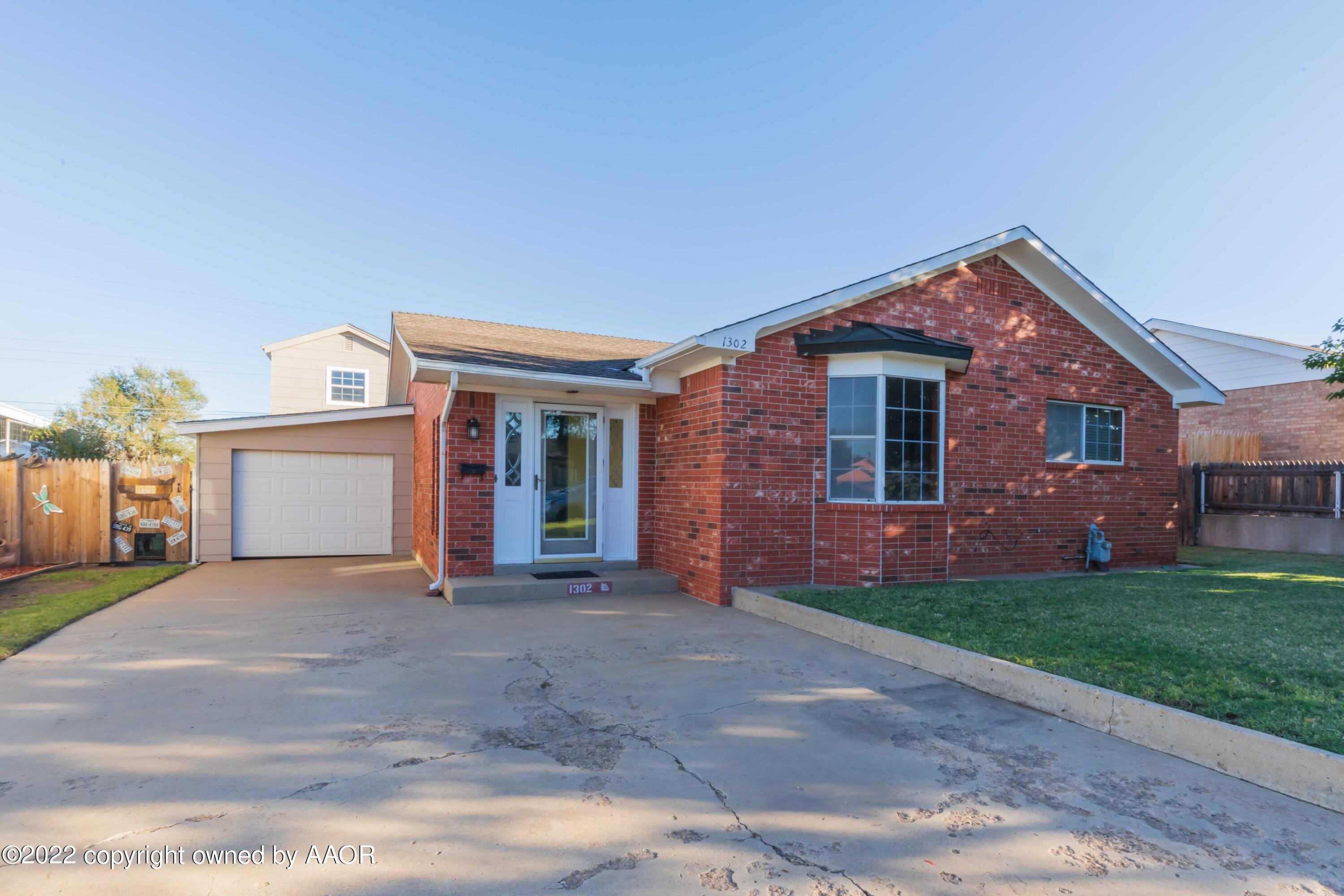 1302 Potter Street Borger, TX 79007 - Photo 3 of 53 a front view of a house with a yard and garage