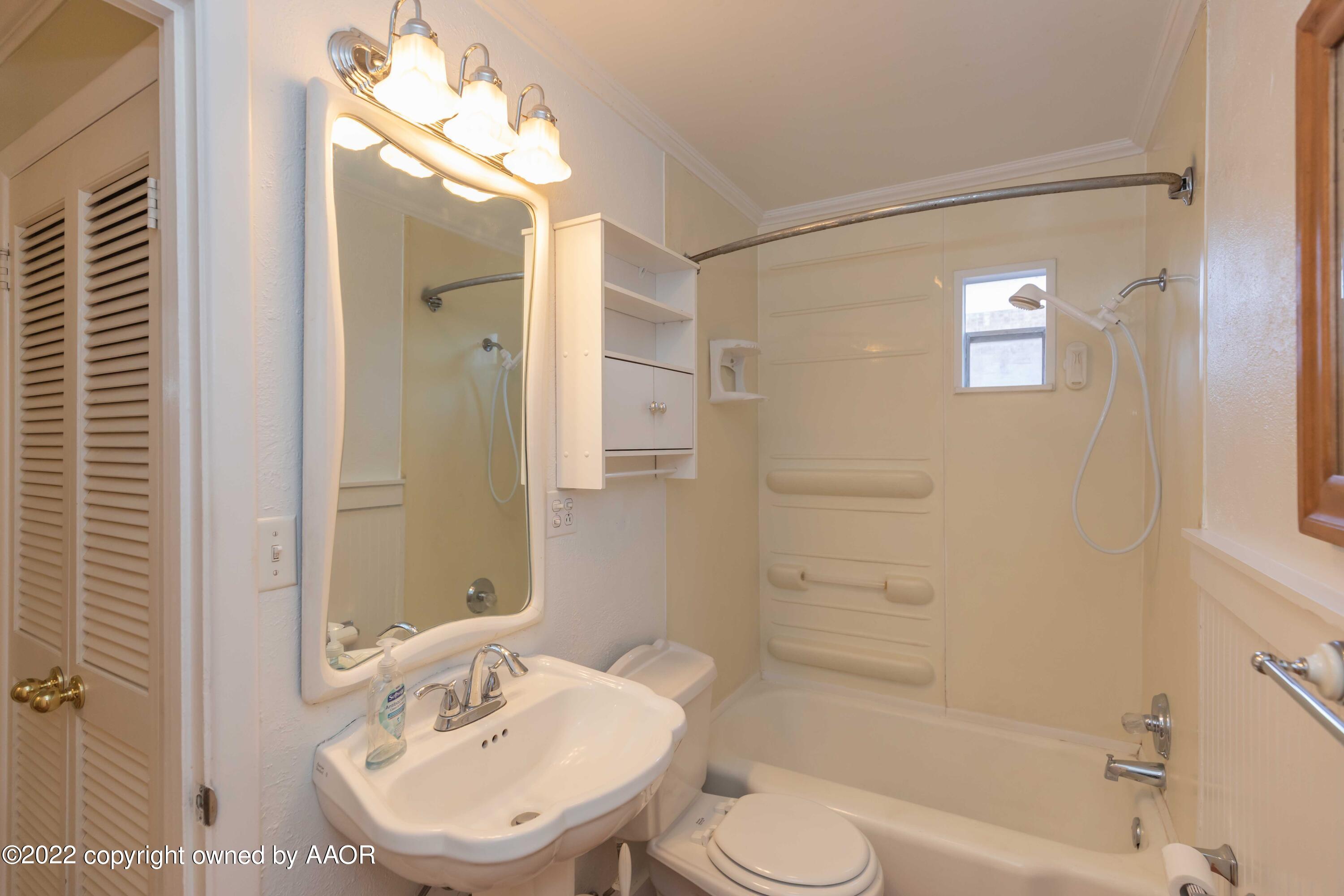 1302 Potter Street Borger, TX 79007 - Photo 39 of 53 a bathroom with a sink toilet a shower and a mirror