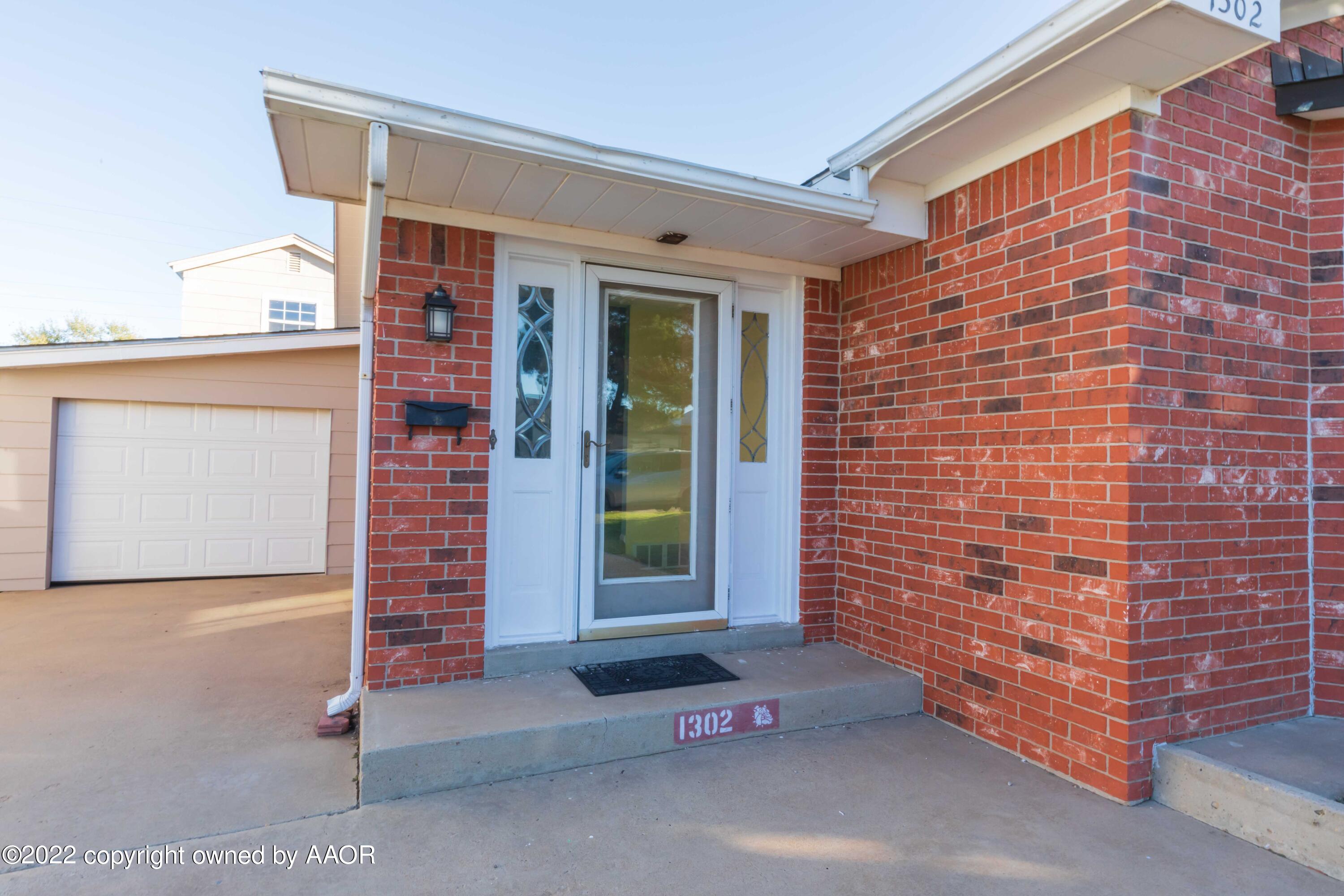 1302 Potter Street Borger, TX 79007 - Photo 4 of 53 a front view of a house with a garage