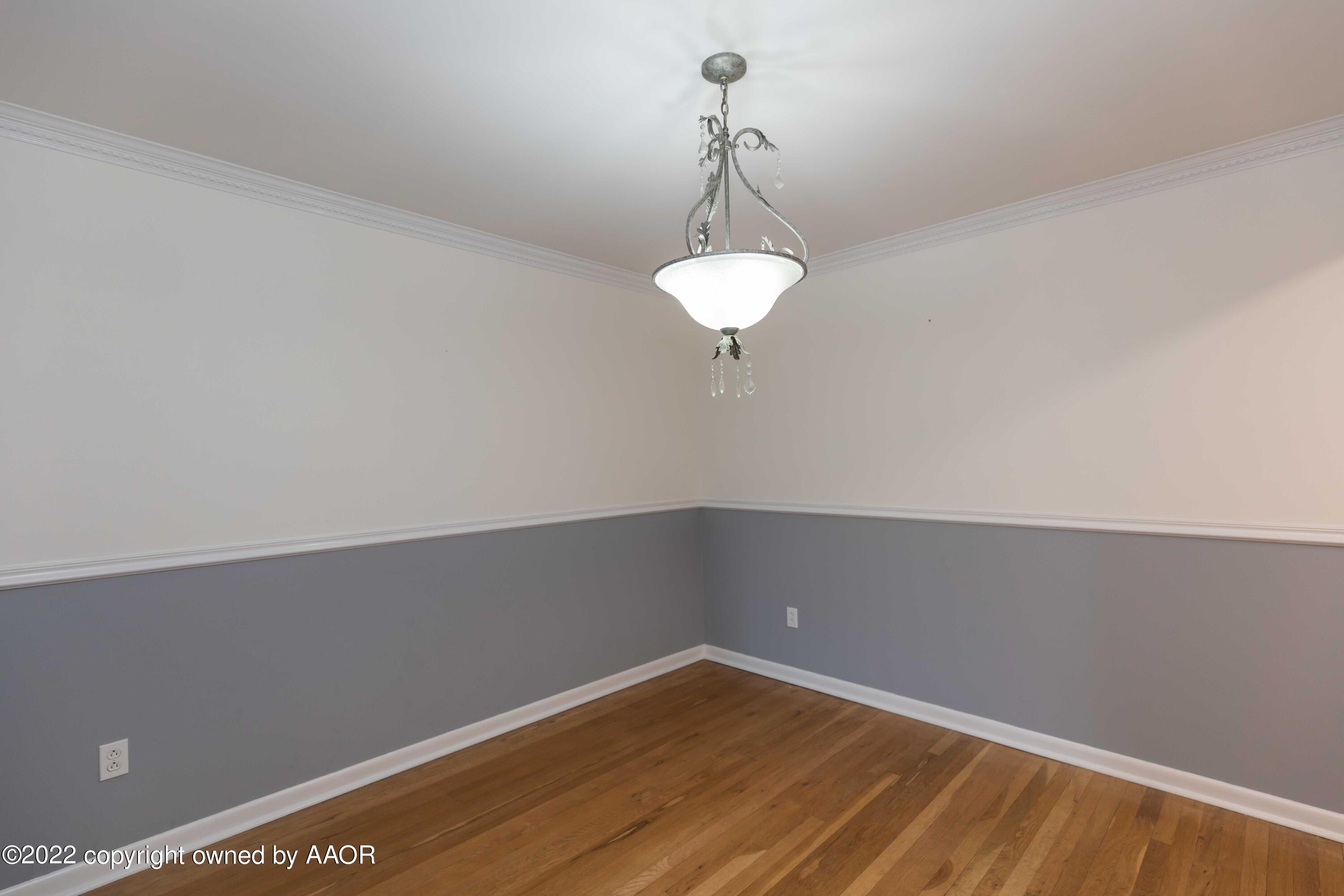 1302 Potter Street Borger, TX 79007 - Photo 10 of 53 a view of a small space with wooden floor and a window