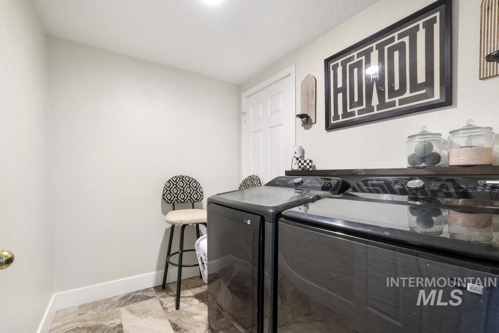 2243 4000 North Filer, ID 83328 - Photo 20 of 30 Laundry room with separate washer and dryer and stone finish flooring