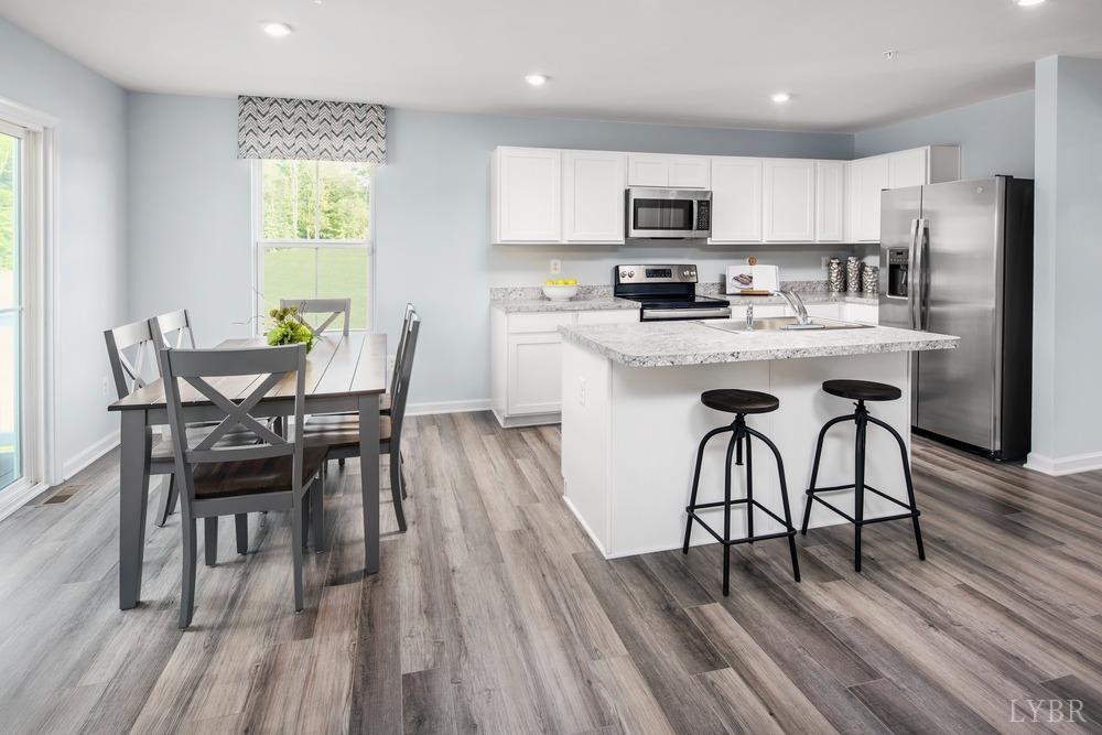 161 Robinia Road Lynchburg, VA 24501 - Photo 4 of 19 a kitchen with stainless steel appliances granite countertop a dining table chairs microwave and sink