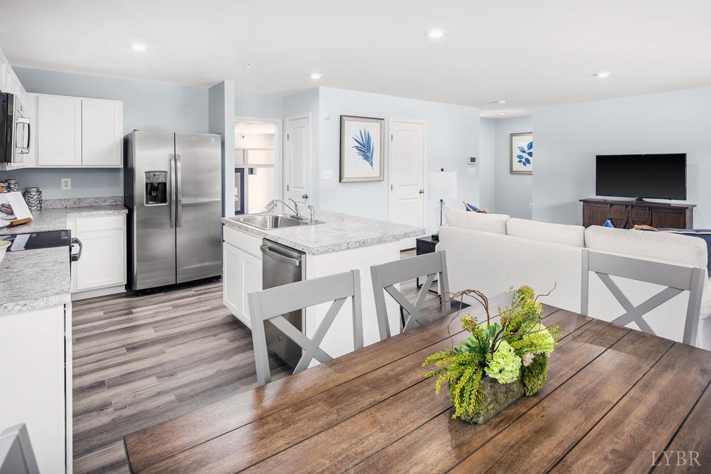 161 Robinia Road Lynchburg, VA 24501 - Photo 6 of 19 a kitchen with stainless steel appliances refrigerator dining table and chairs