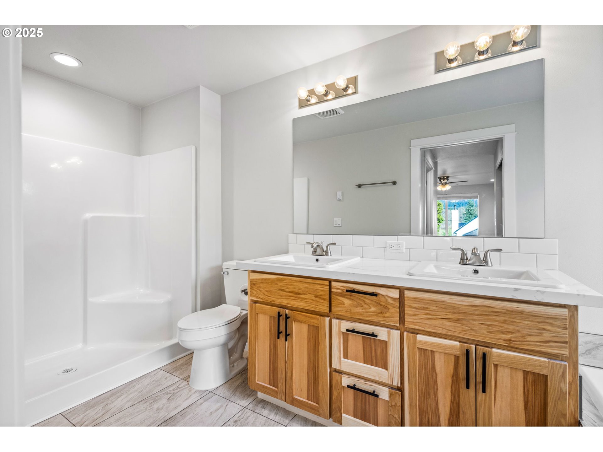 3619 Green River Road Sweet Home, OR 97386 - Photo 14 of 38 a bathroom with a granite countertop sink a toilet a mirror and shower