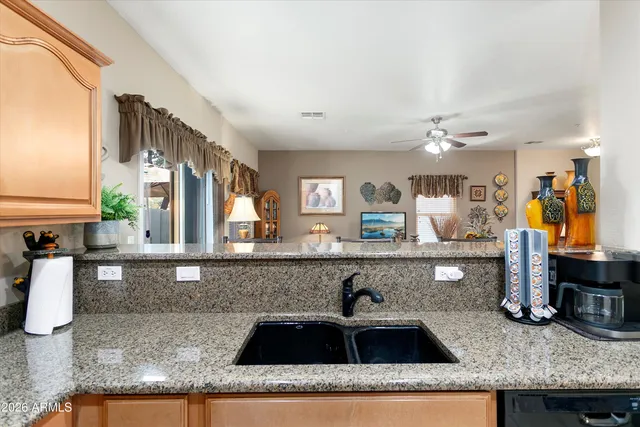 a kitchen with granite countertop a sink and cabinets