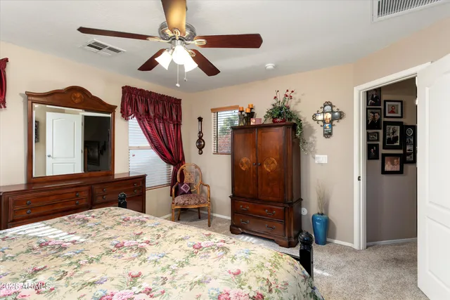 a bedroom with a bed dresser and a window