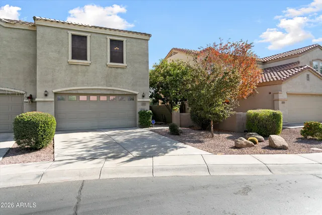 a view of a house with potted plants