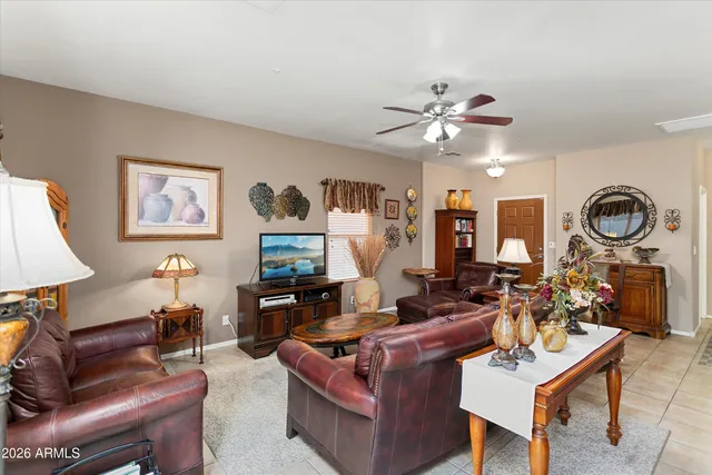 a living room with furniture a clock and a chandelier