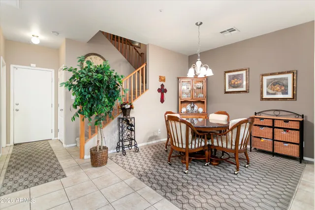 a view of a dining room with furniture and chandelier
