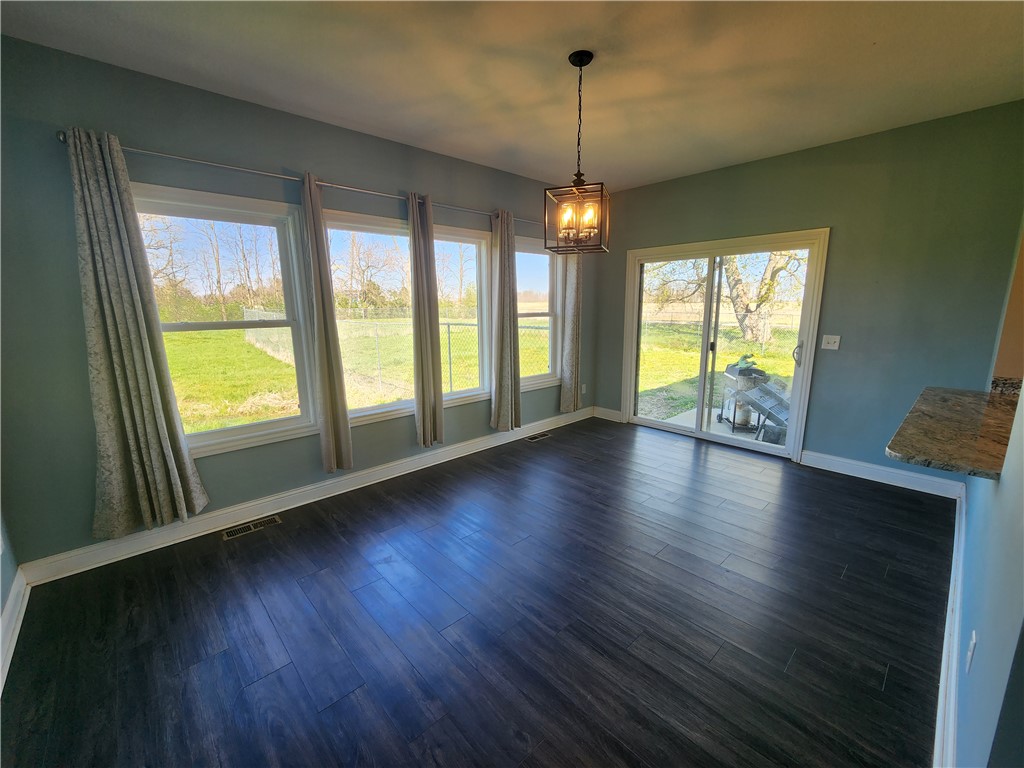 7441 Dodson Road Brookville, OH 45309 - Photo 9 of 50 Bright dining area with ample natural light, durable flooring, and convenient outdoor access.