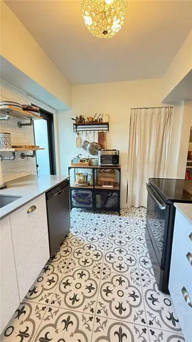 a kitchen with sink and wooden floor