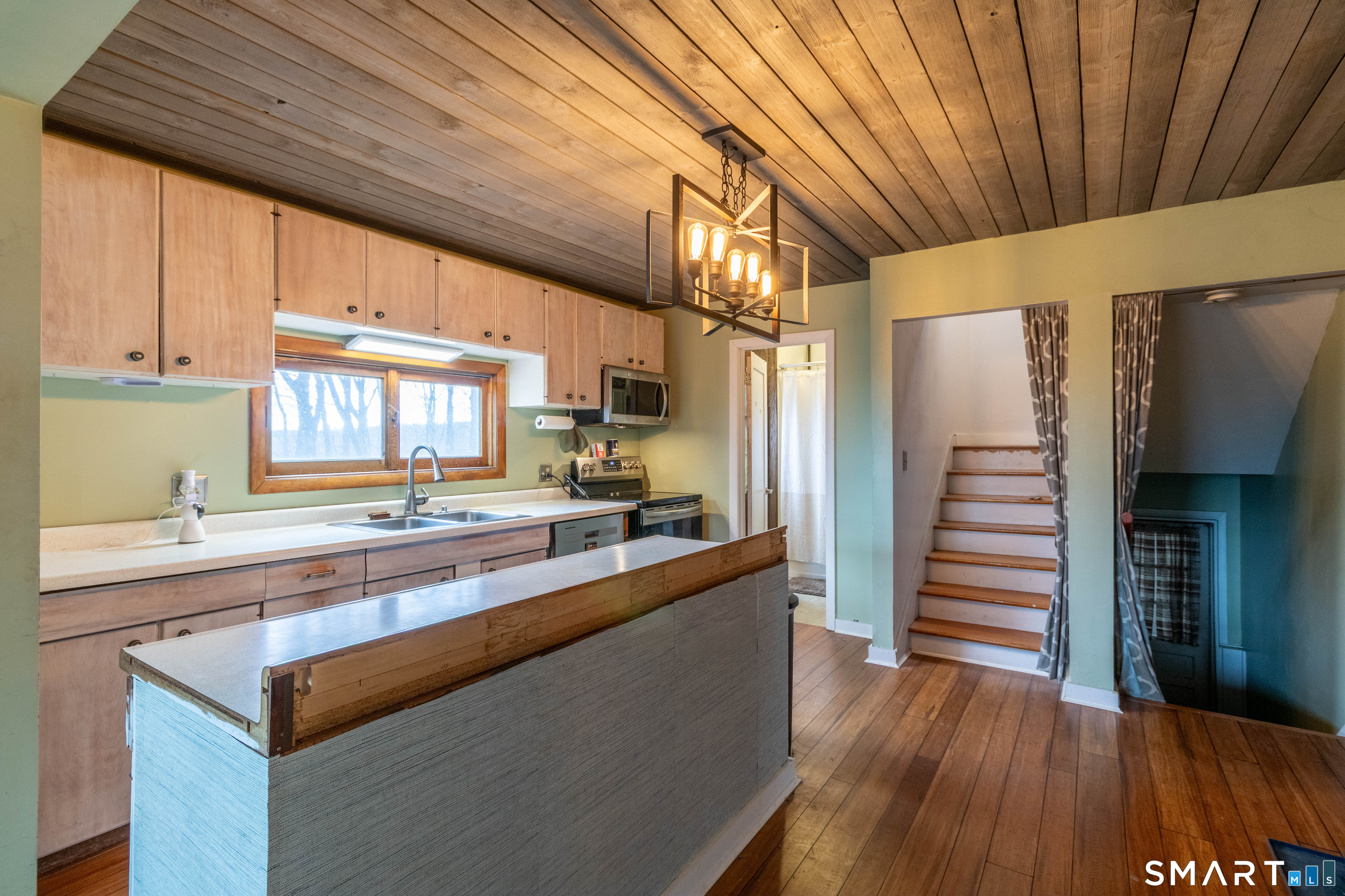 40 Sanitarium Road Windham, CT 06226 - Photo 13 of 33 a kitchen with stainless steel appliances granite countertop a sink a stove and wooden floors