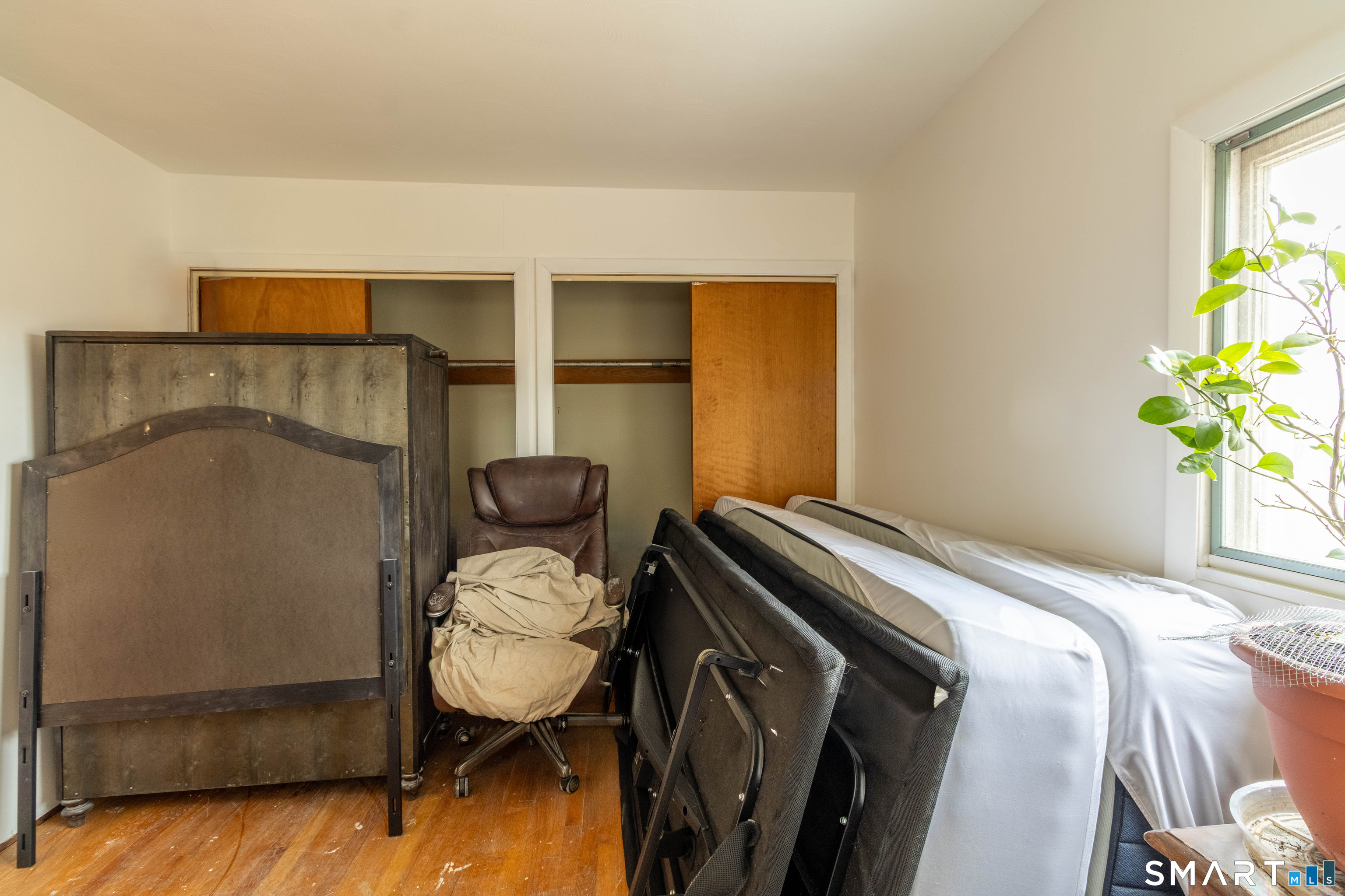 40 Sanitarium Road Windham, CT 06226 - Photo 25 of 33 a bedroom with a bed and a potted plant