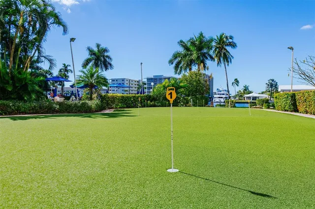 a view of a swimming pool with a chair and tables in the patio