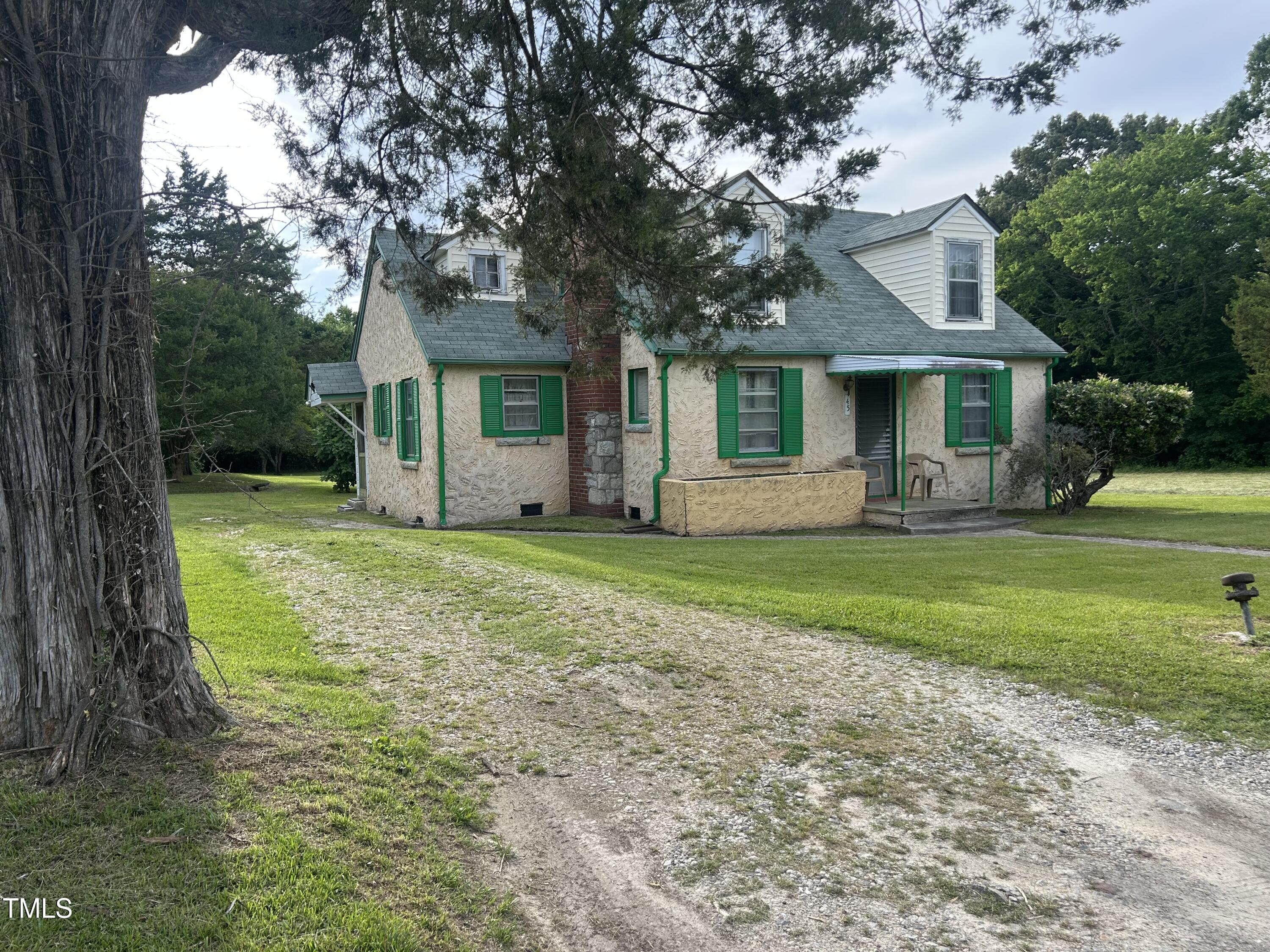 a front view of house with yard and green space