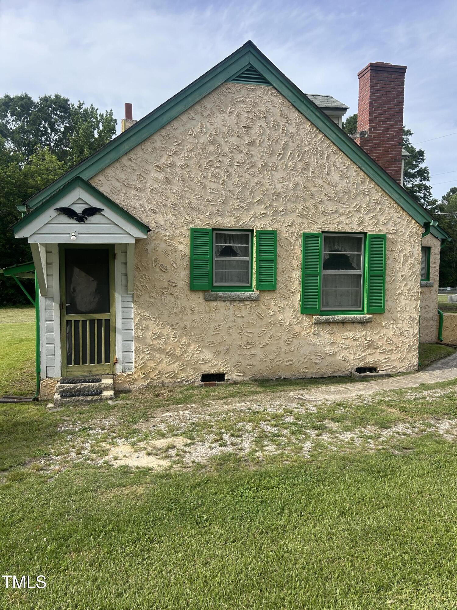 45 Perkinson Street Kittrell, NC 27544 - Photo 3 of 18 a front view of a house with a yard and garage