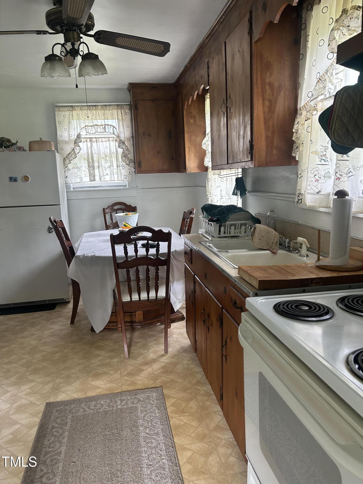 45 Perkinson Street Kittrell, NC 27544 - Photo 4 of 18 a kitchen with a stove a table and chairs in it