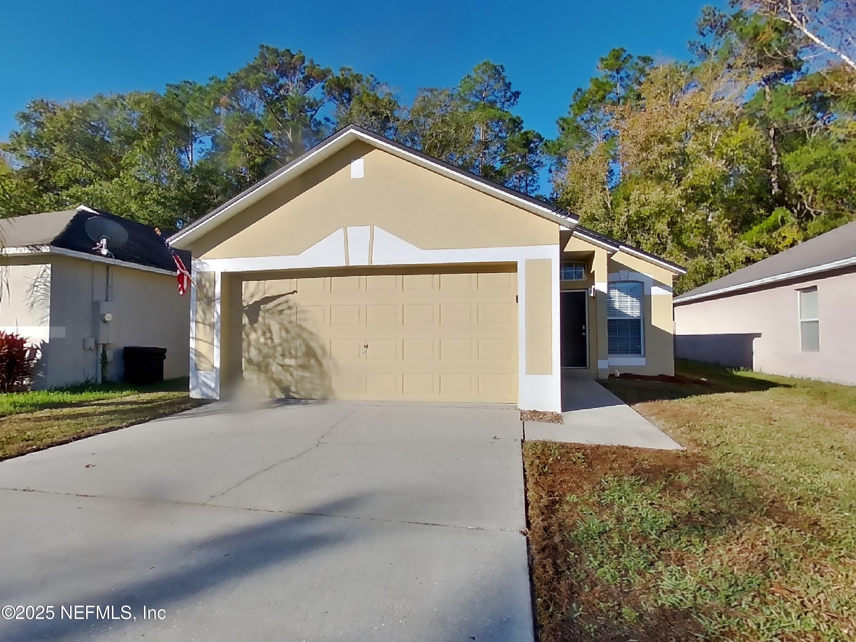 a view of a house with a yard and garage