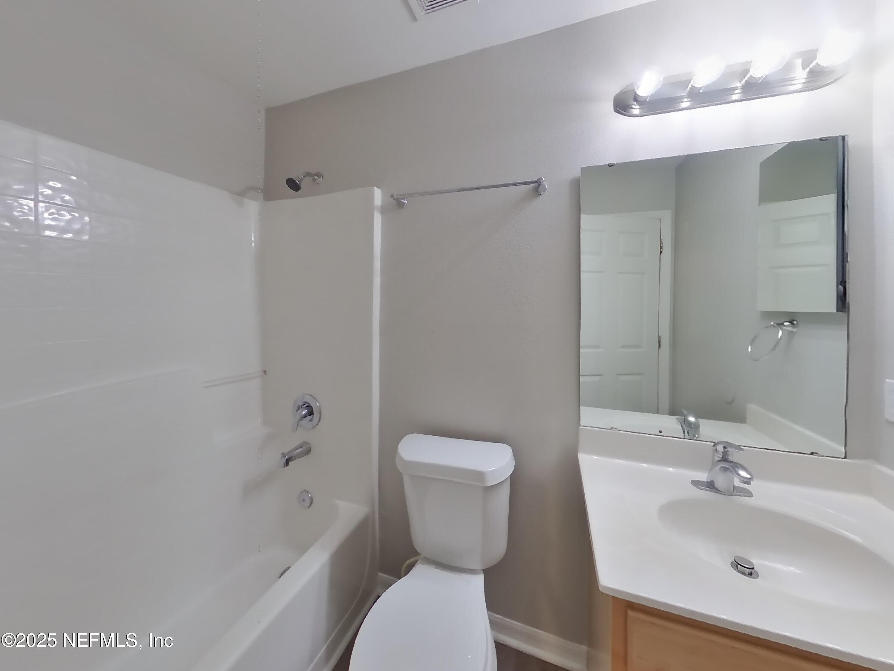 3442 Talisman Drive Middleburg, FL 32068 - Photo 11 of 13 a bathroom with a toilet sink and mirror
