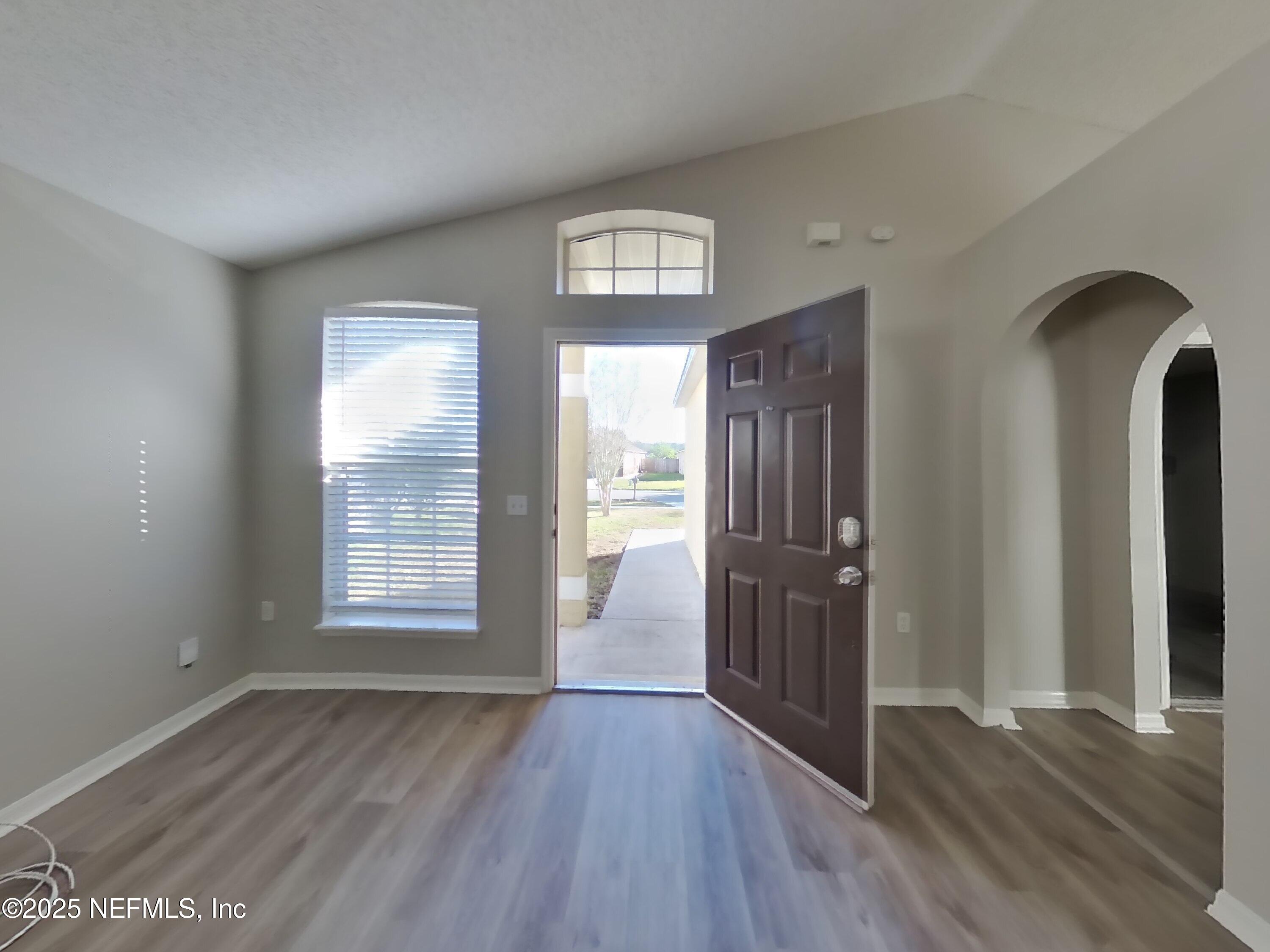 3442 Talisman Drive Middleburg, FL 32068 - Photo 2 of 13 a view of an empty room with wooden floor and a window