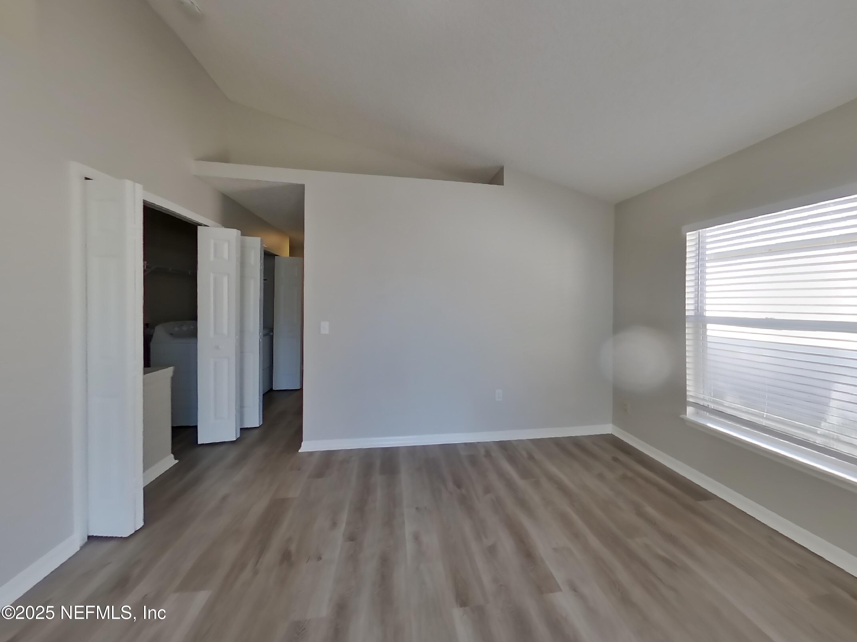 3442 Talisman Drive Middleburg, FL 32068 - Photo 3 of 13 an empty room with wooden floor and windows