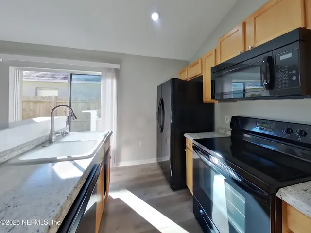 a kitchen with a sink and stainless steel appliances