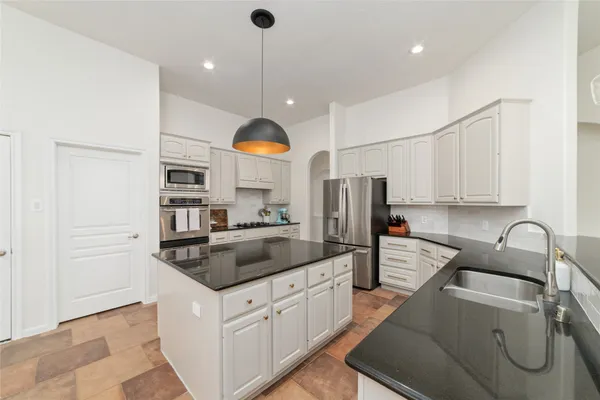 a view of a dining room with furniture and a window